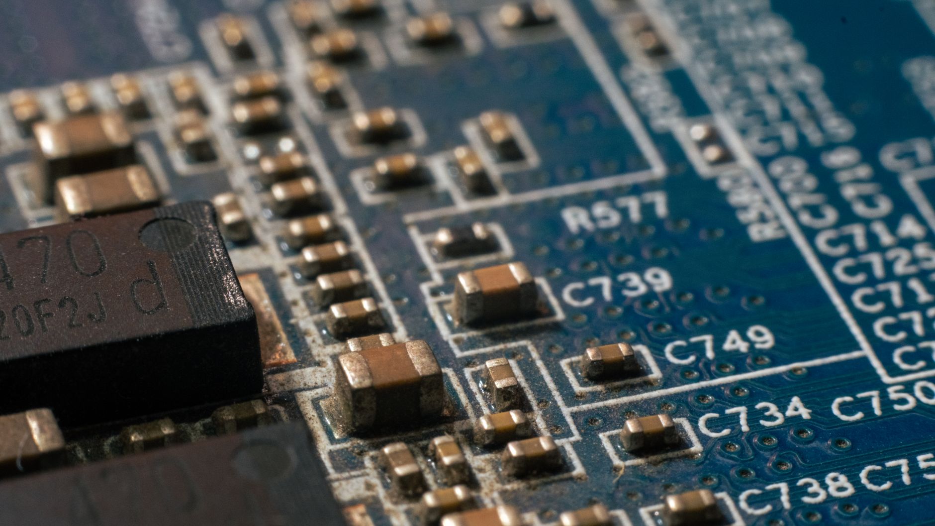 Close-up of a silicon microchip on a circuit board showing complex circuitry