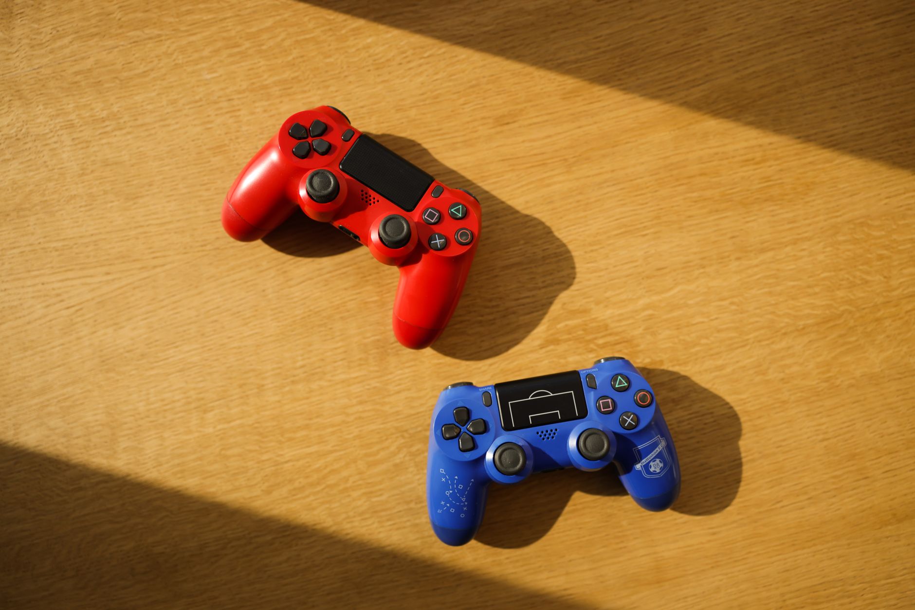 PlayStation-style gaming controller resting on a desk
