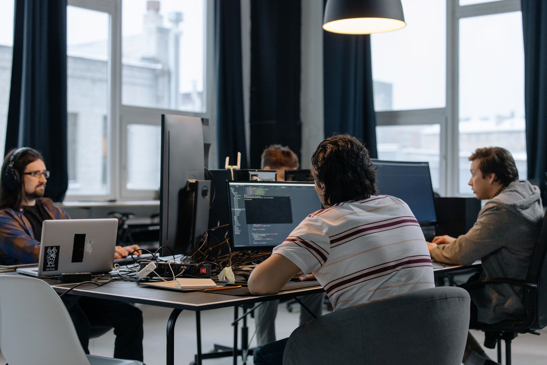 Engineers working at computer workstations in a technology design office