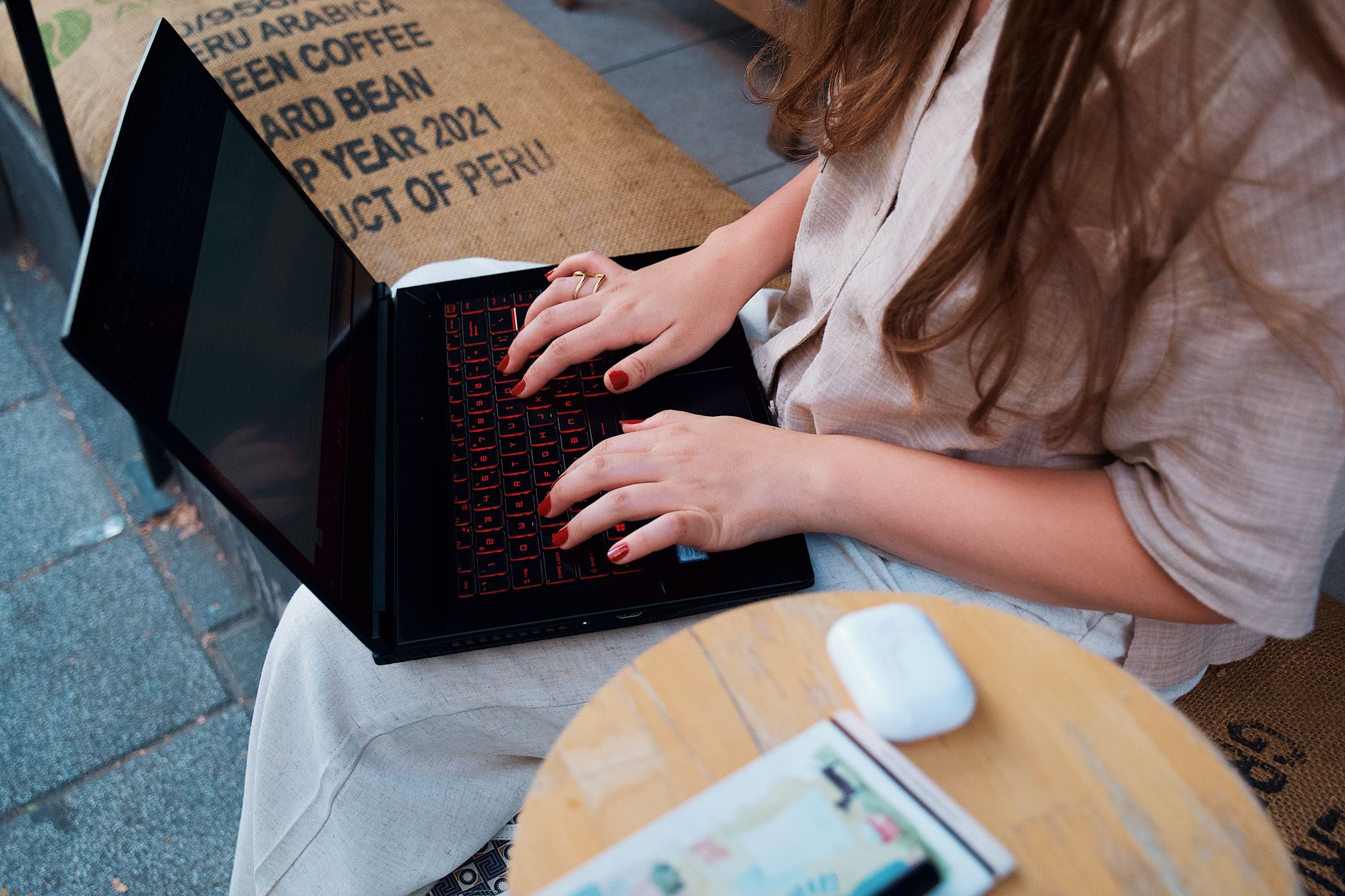 A person working remotely on a laptop in a home setting, representing the digital nomad trend driving long-term rental demand