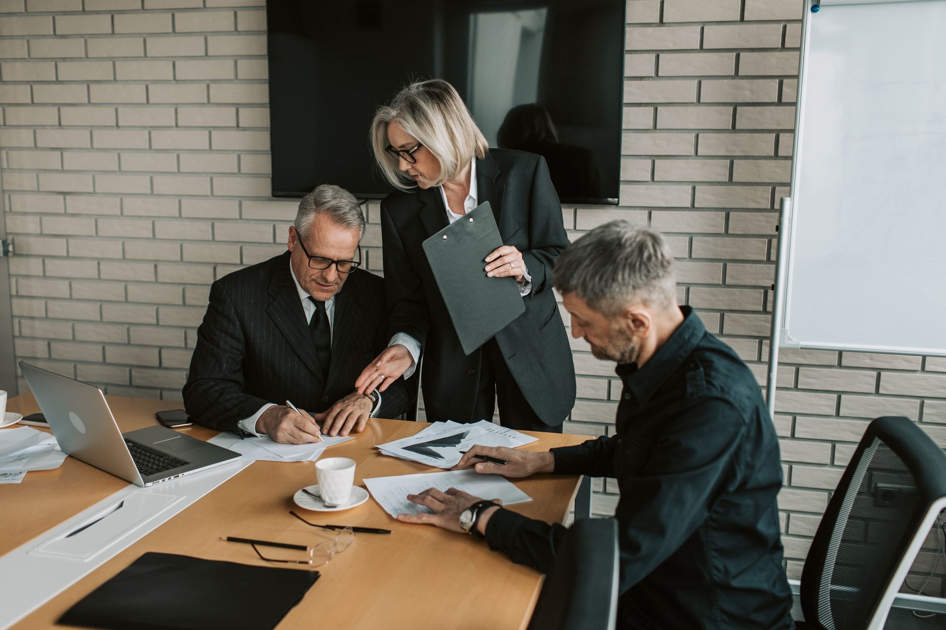 Corporate executives in a boardroom discussion during a strategy meeting
