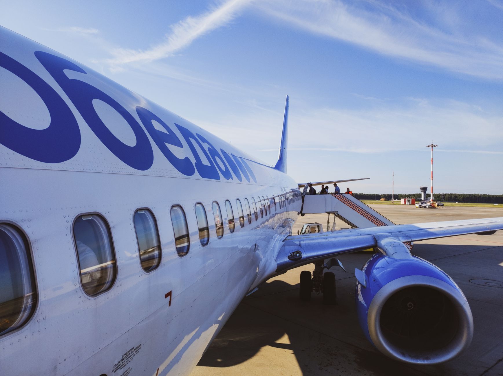 Passengers boarding an aircraft at an airport gate