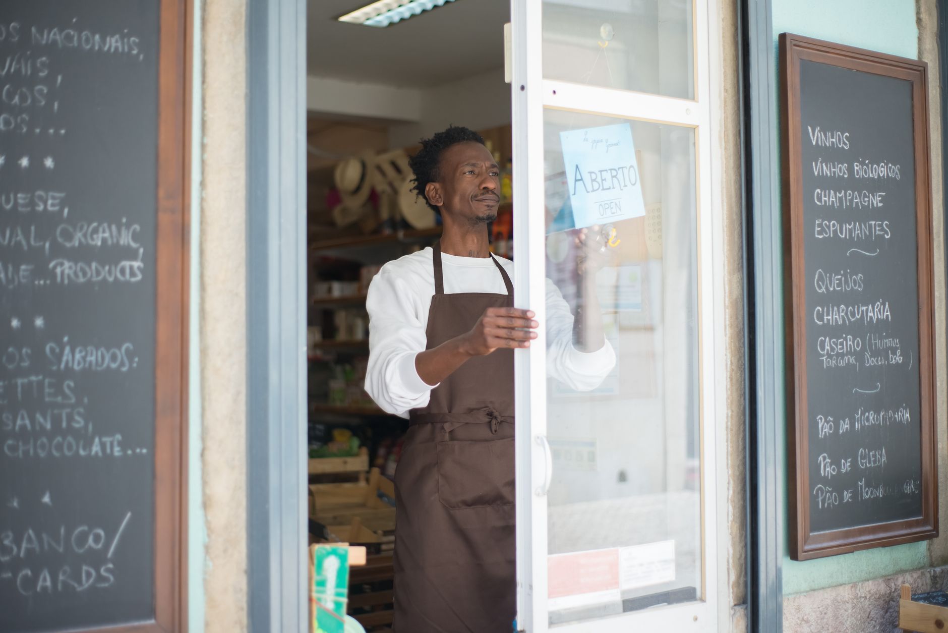 Independent small business owner working at a shop counter, representing Shopify's original merchant base