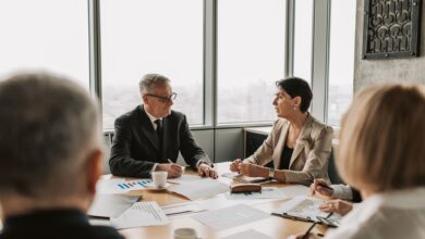 Business professionals reviewing financial documents in a corporate meeting room