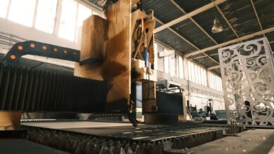 Workers on an aerospace manufacturing floor assembling large aircraft components