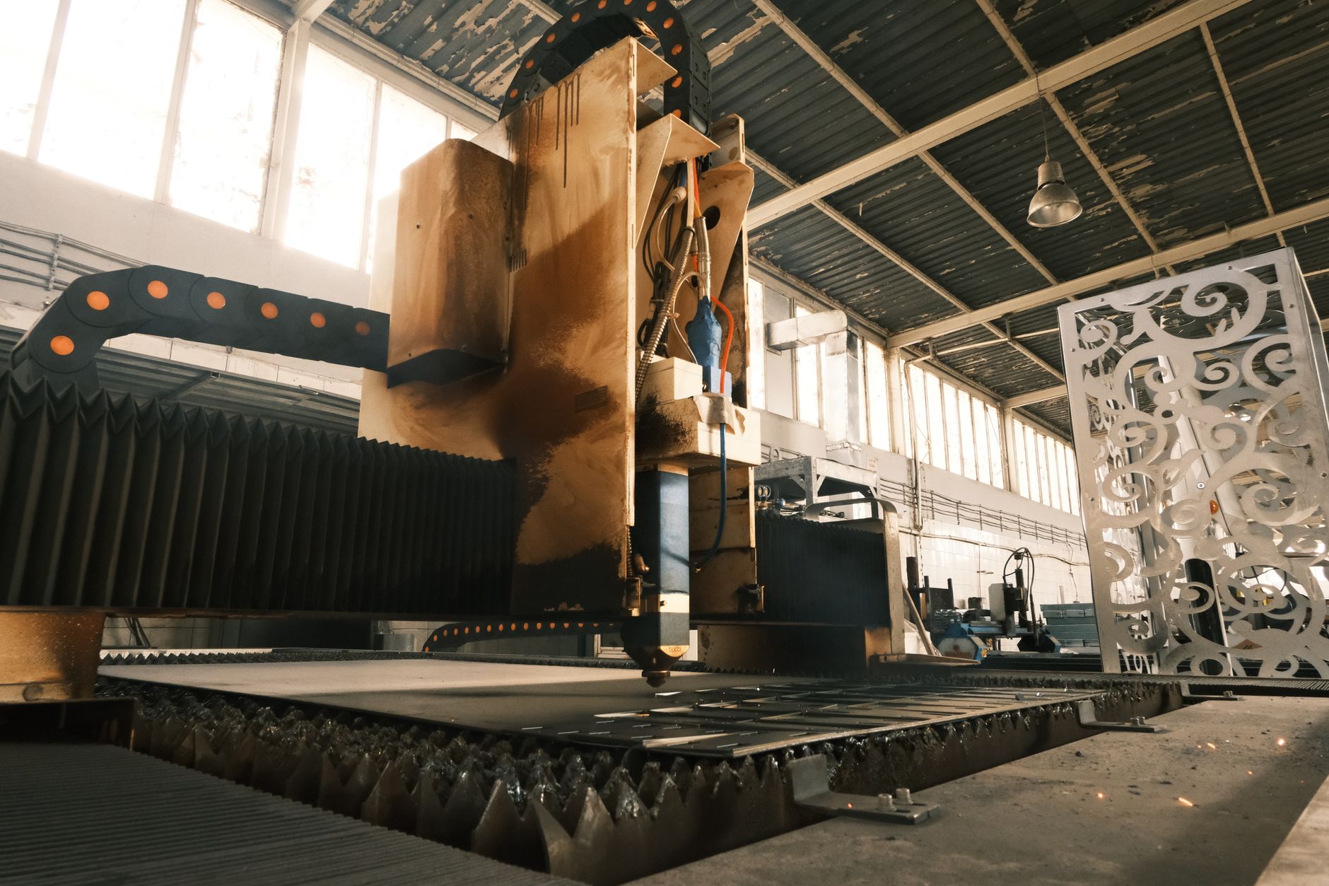 Workers on an aerospace manufacturing floor assembling large aircraft components
