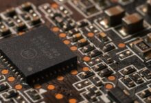 Close-up of a semiconductor chip on a circuit board representing AI hardware development