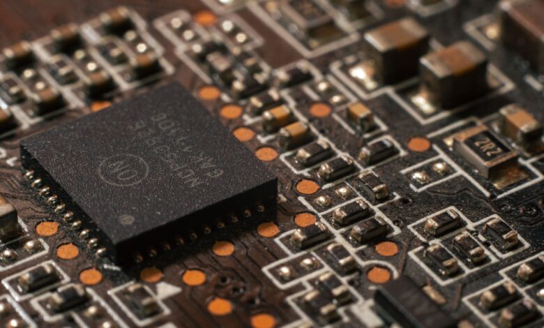 Close-up of a semiconductor chip on a circuit board representing AI hardware development