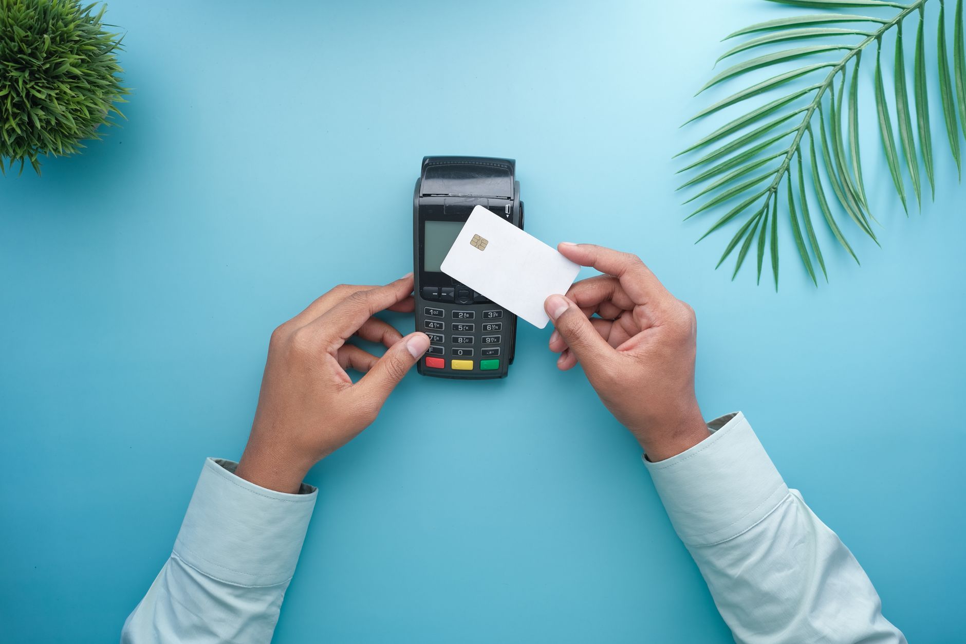 A shopper using a contactless payment terminal at a retail checkout counter