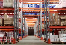 Wide aisle inside a large warehouse retail store stocked with bulk goods