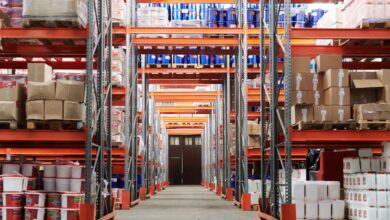 Wide aisle inside a large warehouse retail store stocked with bulk goods