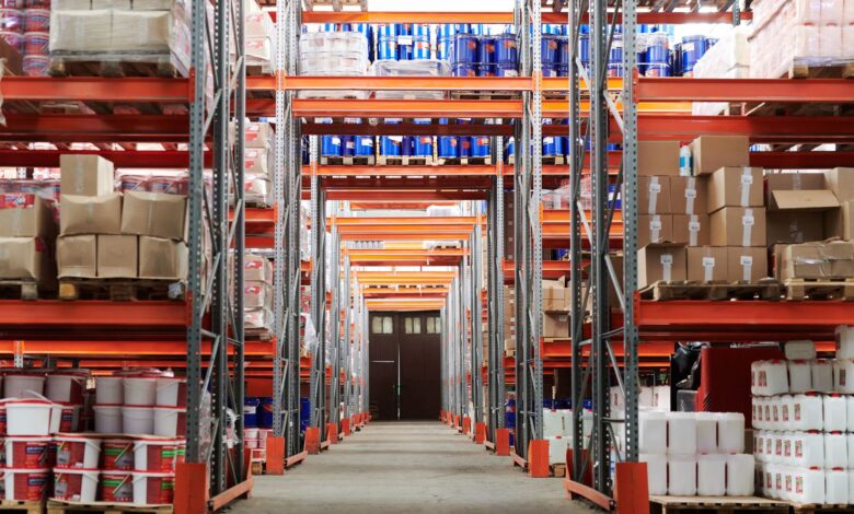 Wide aisle inside a large warehouse retail store stocked with bulk goods