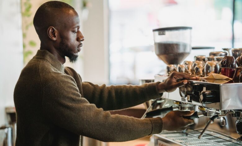 Barista preparing drinks behind a busy coffee shop counter