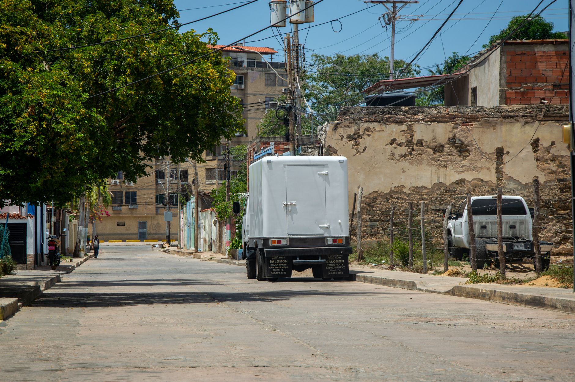 Electric pickup truck driving on an open highway representing Rivian consumer vehicles