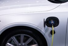 A hybrid vehicle driving on an open highway representing fuel-efficient automotive technology