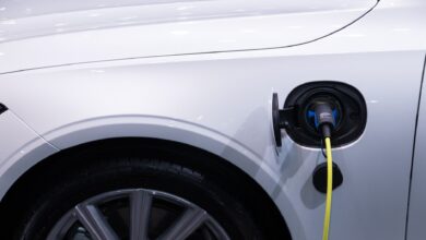 A hybrid vehicle driving on an open highway representing fuel-efficient automotive technology