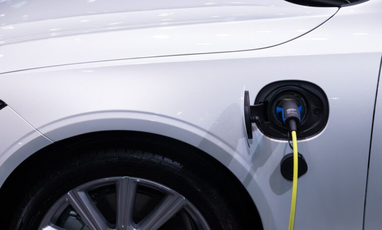 A hybrid vehicle driving on an open highway representing fuel-efficient automotive technology