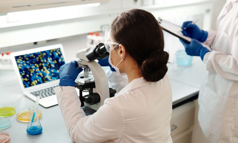 Scientist working in a biotech laboratory examining samples under controlled conditions