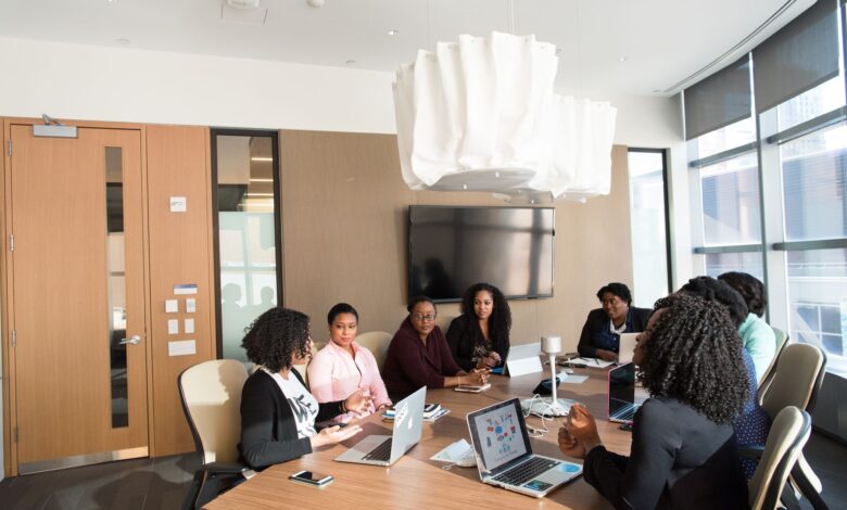 Business professionals working with enterprise software on large monitors in a modern office setting