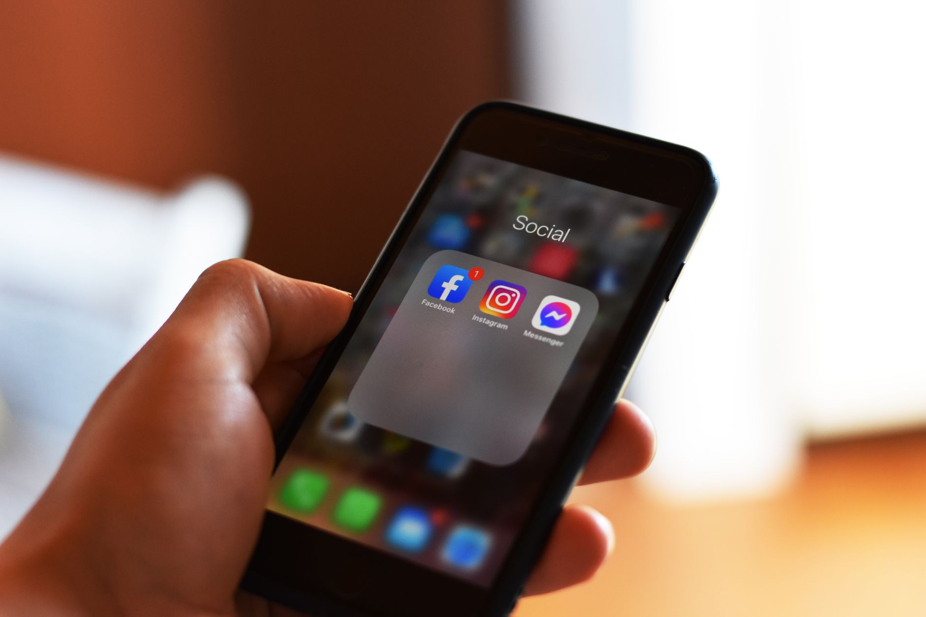 Person scrolling through a social media feed on a smartphone