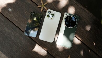 Row of iPhones displayed on a table showing different models side by side