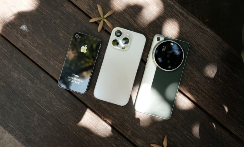 Row of iPhones displayed on a table showing different models side by side