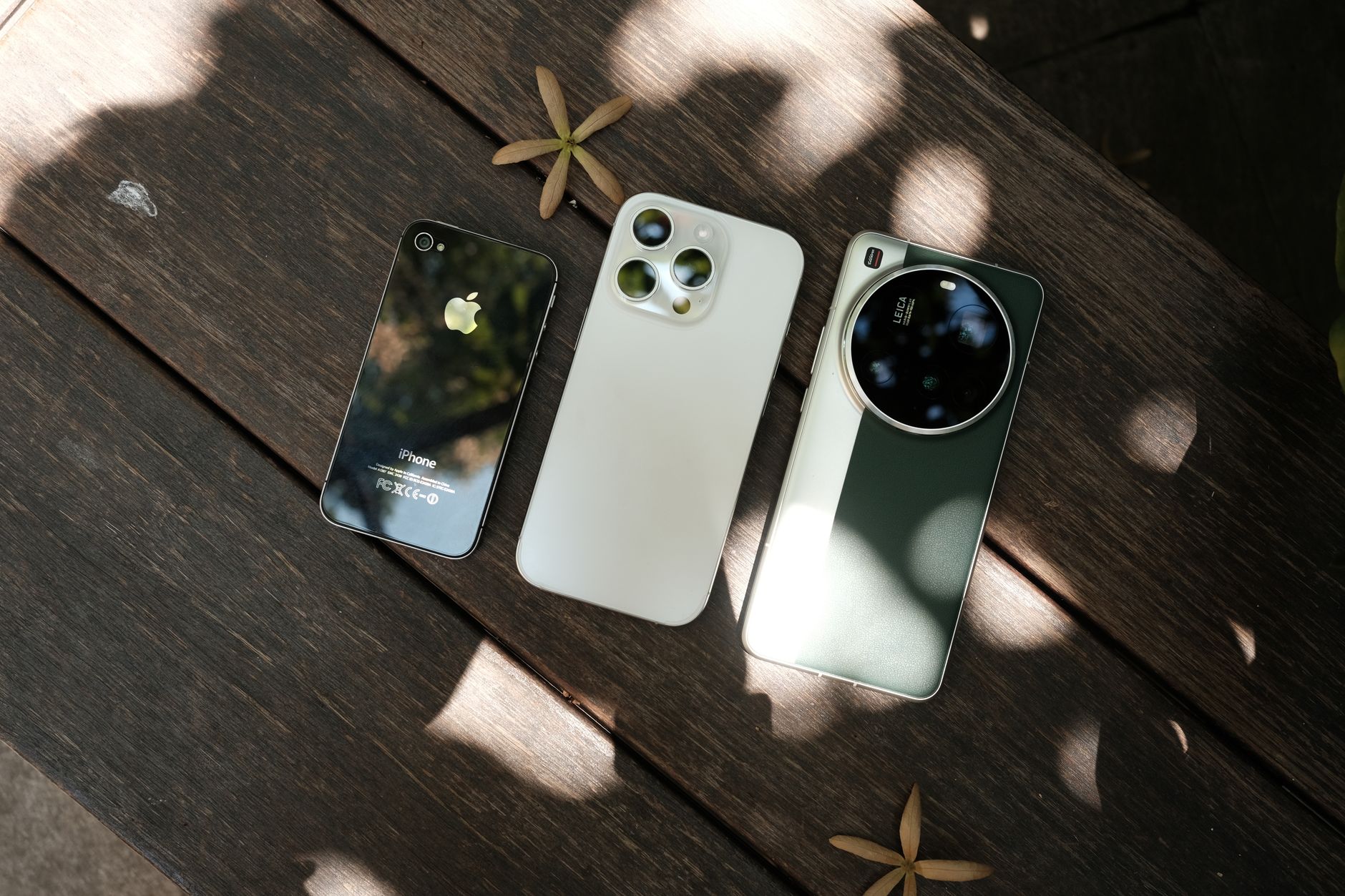 Row of iPhones displayed on a table showing different models side by side