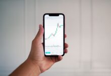Person using a mobile trading app on a smartphone