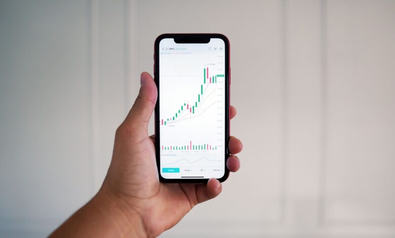 Person using a mobile trading app on a smartphone