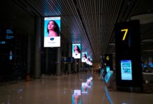 Multiple digital advertising screens displaying online ad content in an urban setting