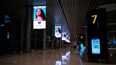 Multiple digital advertising screens displaying online ad content in an urban setting