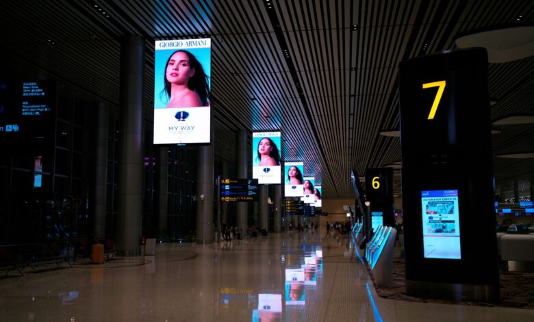 Multiple digital advertising screens displaying online ad content in an urban setting