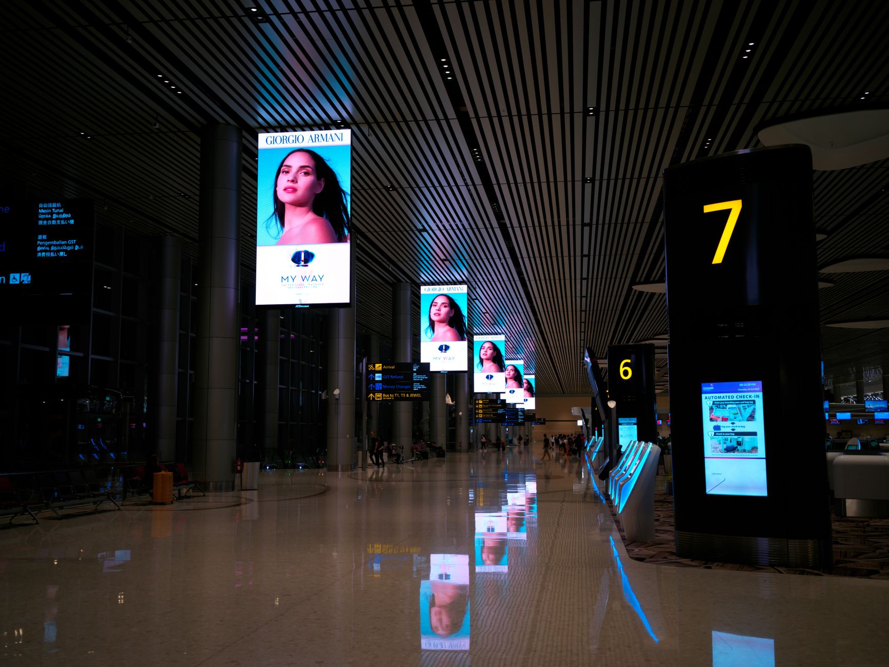 Multiple digital advertising screens displaying online ad content in an urban setting