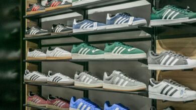 Athletic sneakers displayed on a retail store wall with organized shelving