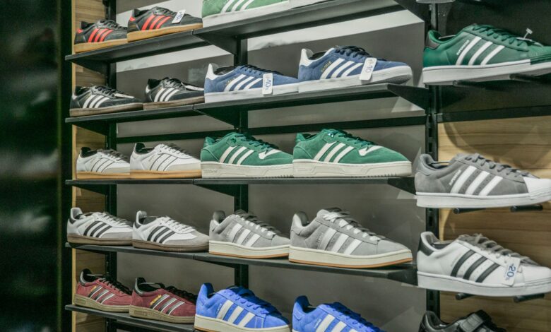 Athletic sneakers displayed on a retail store wall with organized shelving