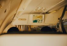 Business class cabin interior showing premium airline seats with personal screens