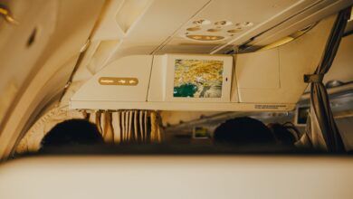 Business class cabin interior showing premium airline seats with personal screens