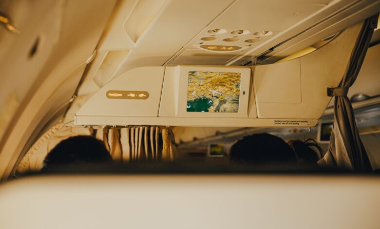 Business class cabin interior showing premium airline seats with personal screens