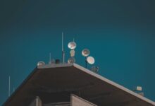 A satellite dish installed in a rural area representing remote internet connectivity options