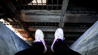 Rows of sneakers stored in a large warehouse facility representing unsold footwear inventory