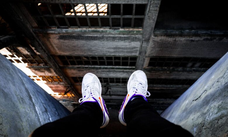 Rows of sneakers stored in a large warehouse facility representing unsold footwear inventory