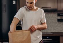 A grocery delivery bag sitting on a doorstep representing on-demand grocery services