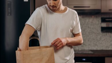 A grocery delivery bag sitting on a doorstep representing on-demand grocery services