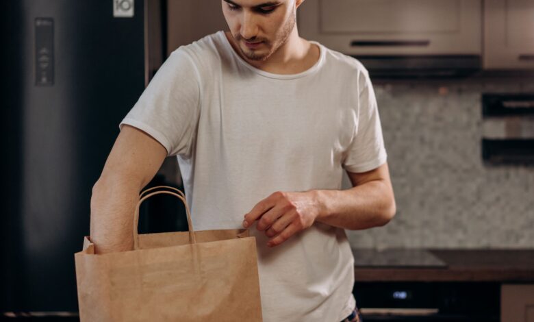 A grocery delivery bag sitting on a doorstep representing on-demand grocery services