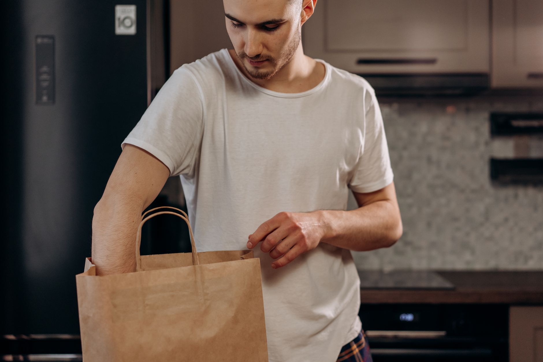 A grocery delivery bag sitting on a doorstep representing on-demand grocery services