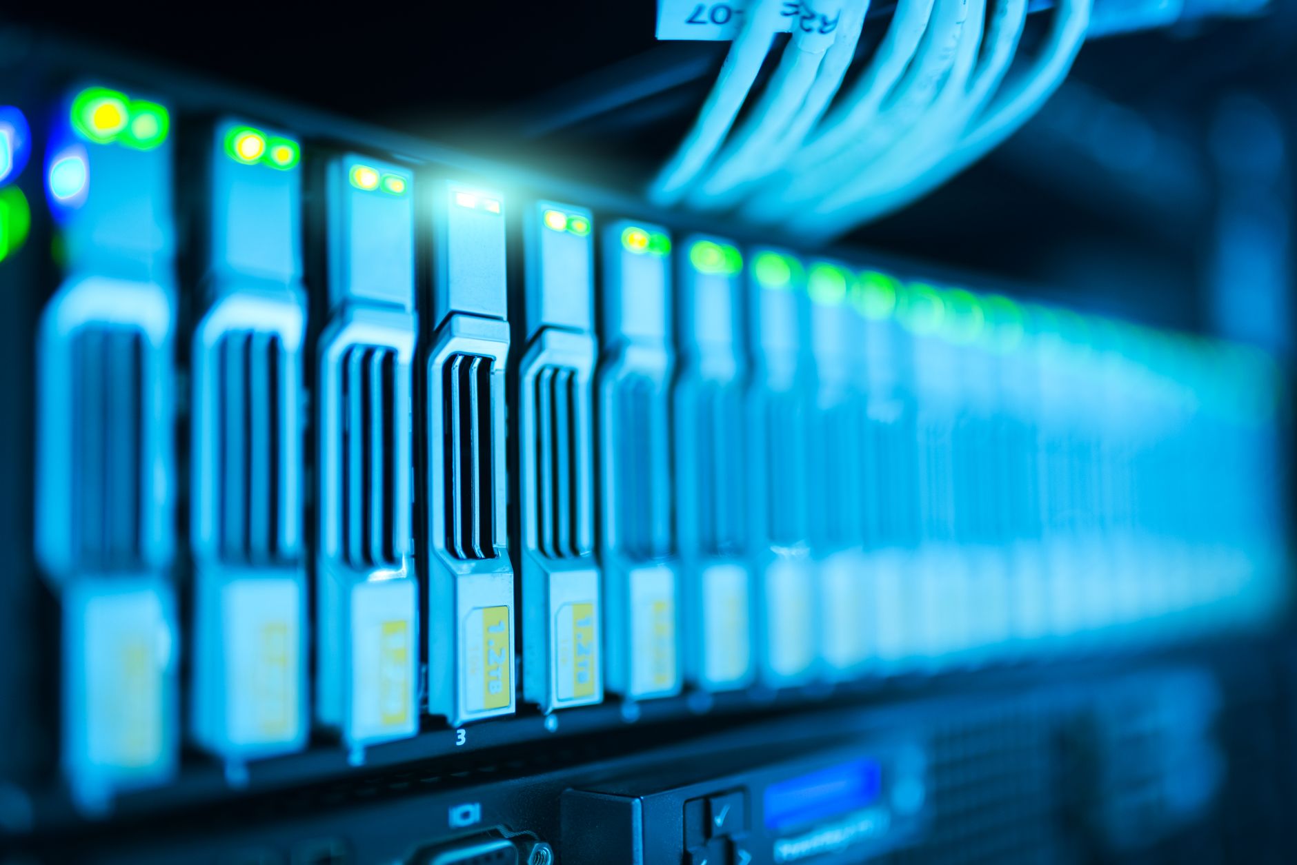 Rows of servers inside a large data center facility representing AI infrastructure buildout