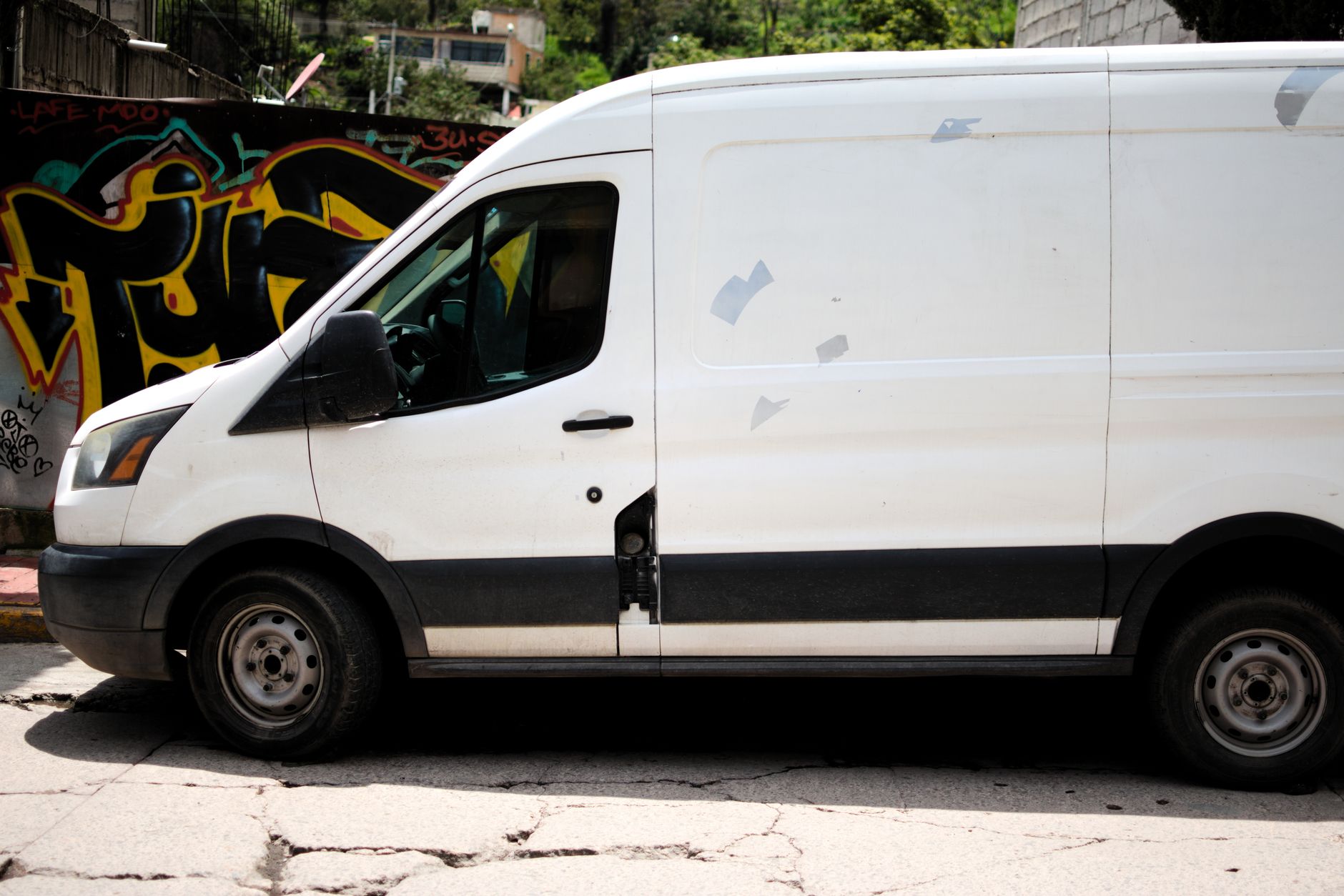 Electric delivery vans parked on a city street representing Amazon last-mile logistics fleet