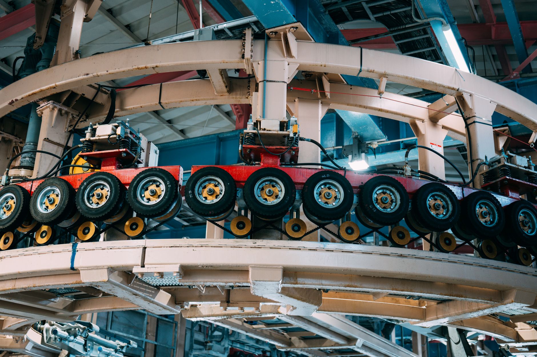 Workers on an automotive assembly line producing vehicles in a modern manufacturing plant