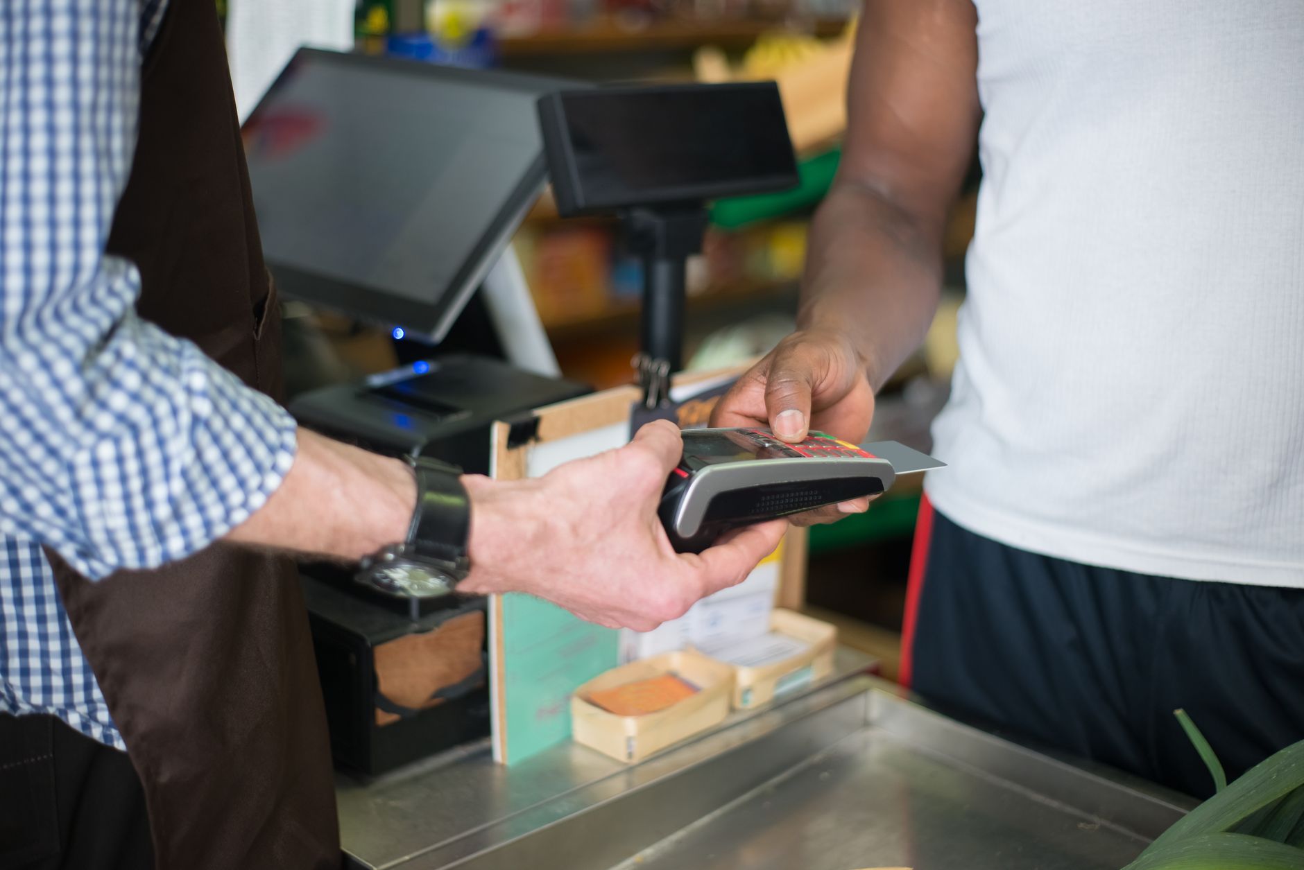 A small business owner reviewing transactions on a tablet-based point-of-sale system