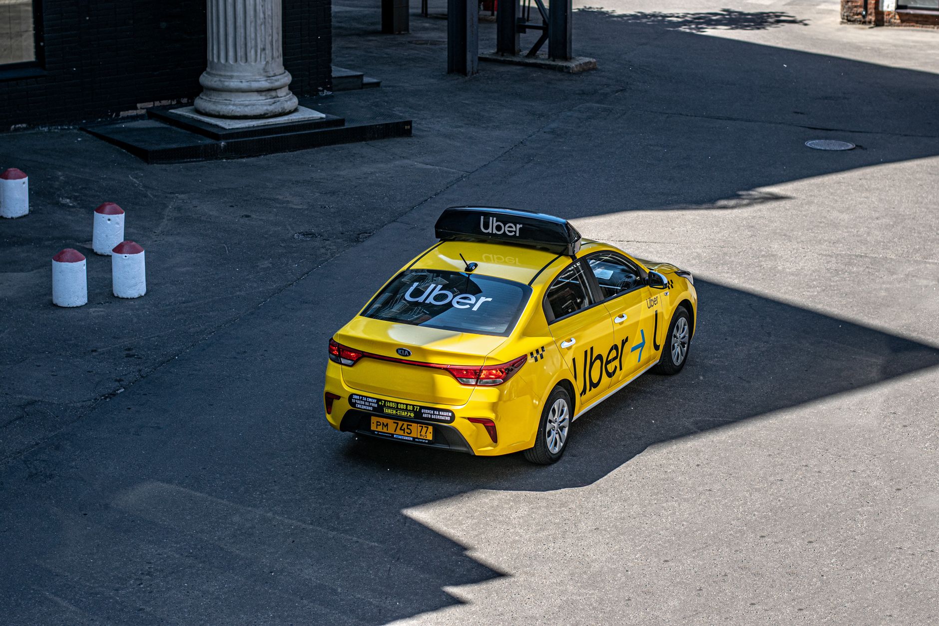 A smartphone showing a ride-hailing app interface symbolizing competition between Waymo and Uber